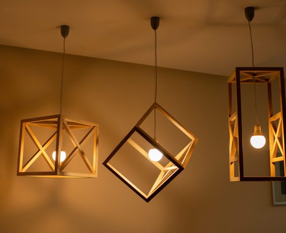 Modern ceiling lights bulbs lamp made of wooden frame geometric shape interior and loft style decorating with white wooden wall.